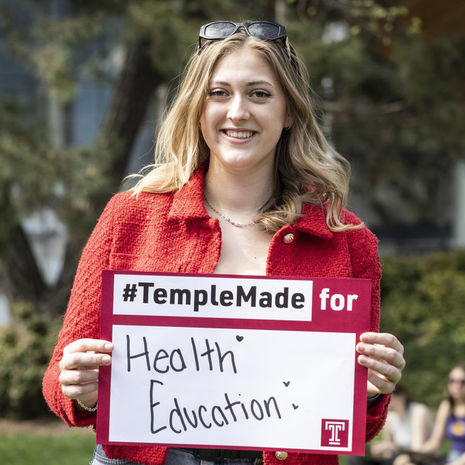 Meredith Kearney holding a Temple Made for sign