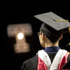 Student wearing a cap and gown at Commencement