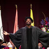 Colman Domingo on stage at Commencement smiling with arms open to crowd