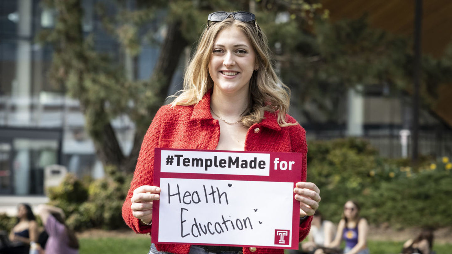 Meredith Kearney holding a Temple Made for sign
