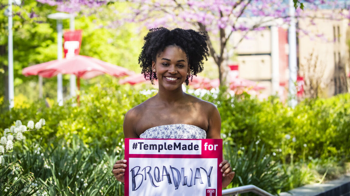 During her time at Temple, musical theater major Jasmine Villaroel made her Broadway debut in The Great Gatsby. Jasmine Villaroel holding a Temple Made for sign outside on Main Campus