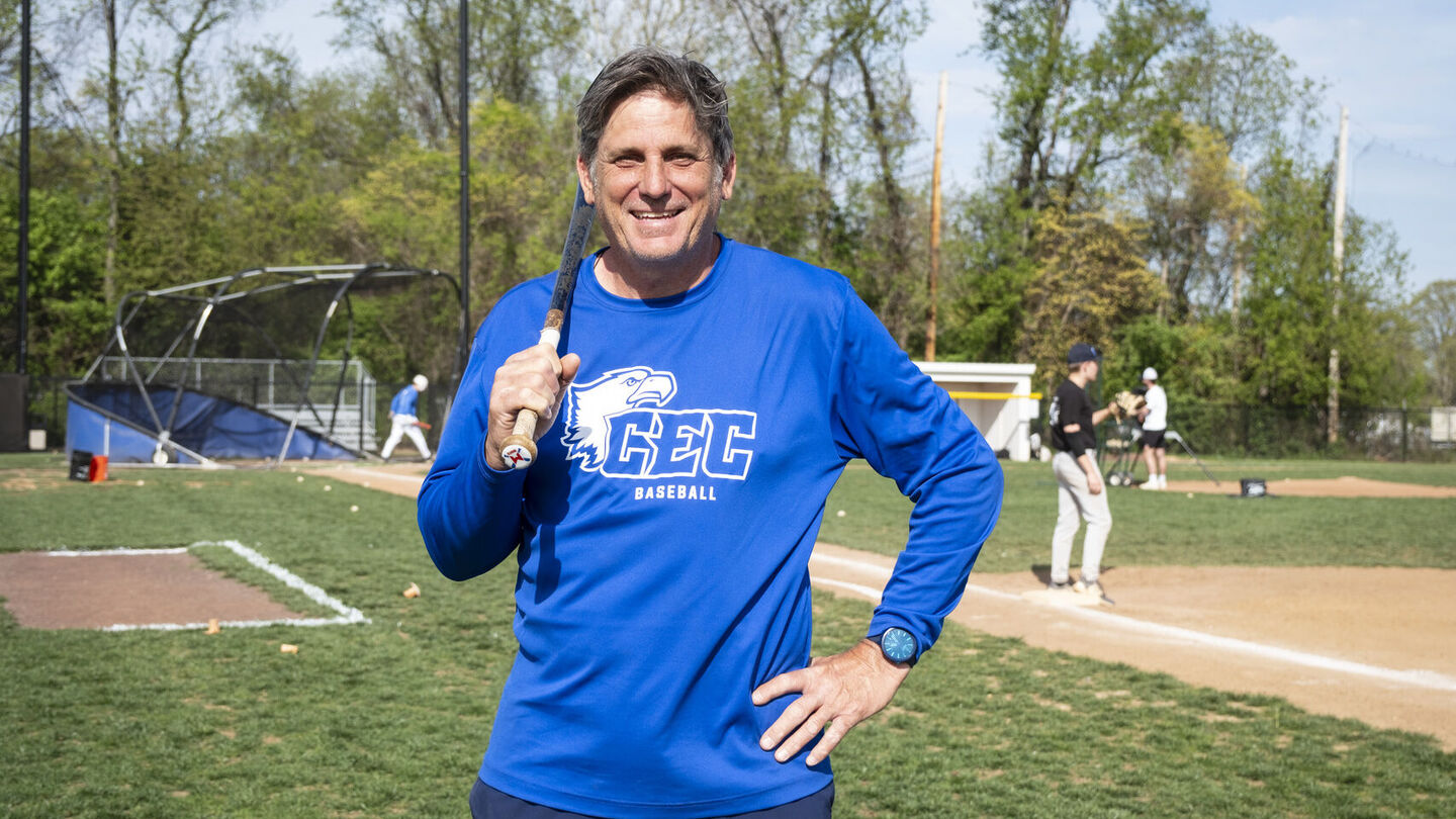 Jeff Manto played three seasons (1983–1985) at Temple under legendary Coach Skip Wilson and was selected by the California Angels in the 1985 MLB draft following his junior season. Manto played 10 seasons of Major League Baseball and is currently the head baseball coach at Conwell-Egan Catholic High School. Image of a person wearing a blue shirt and holding up baseball bat on a field.